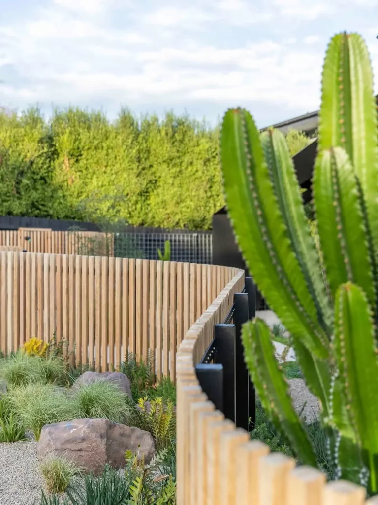 curved timber fence with plants