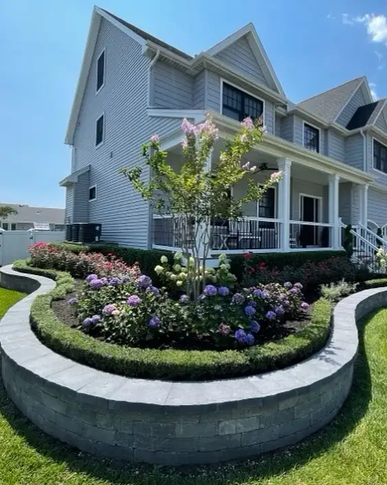 curved grey stone front wall garden